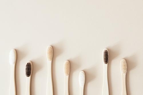 Bamboo toothbrushes on a beige background - 2255812