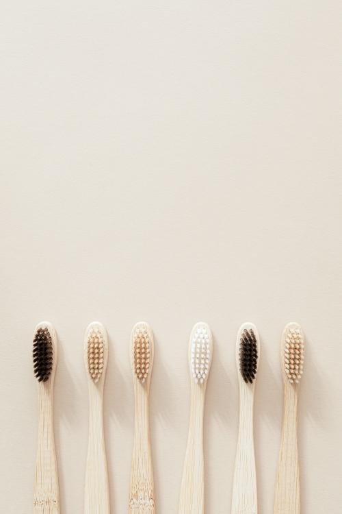 Bamboo toothbrushes on a beige background - 2255814