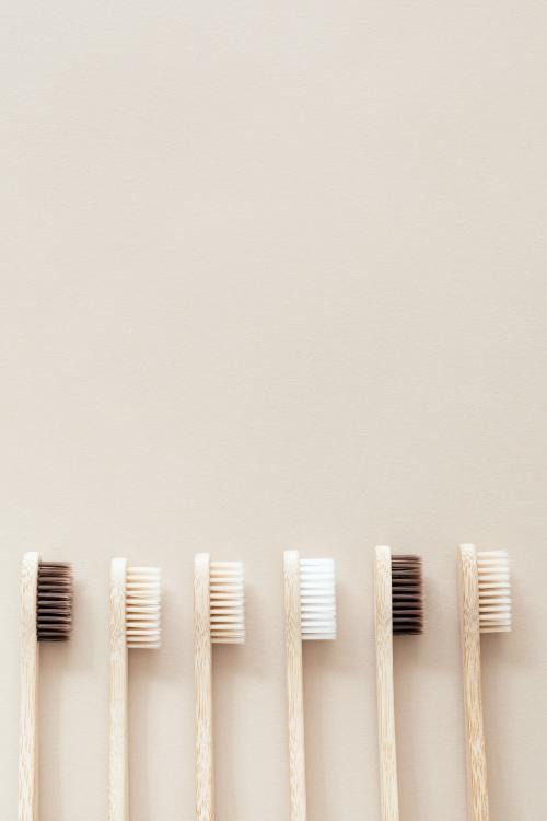 Bamboo toothbrushes on a beige background - 2255824