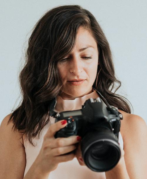 Female photographer holding digital camera - 1224219