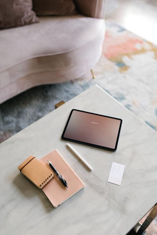 Digital tablet on a white marble table in a living room - 1216776