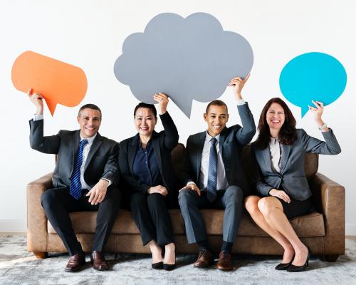 Cheerful business people holding speech bubble - 414527