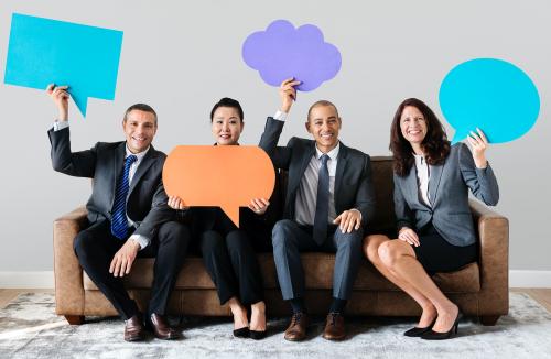 Cheerful business people holding speech bubble - 414586
