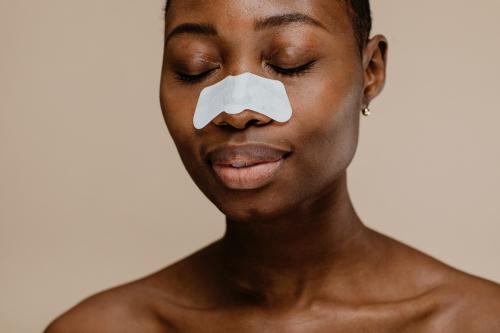 Black woman with a nose pore strip - 1203373