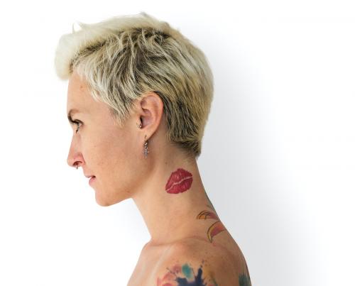 Profile portrait of a blonde woman with tattoos - 7215