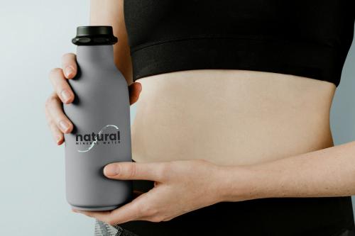 Sportive woman with a water bottle mockup - 1216462