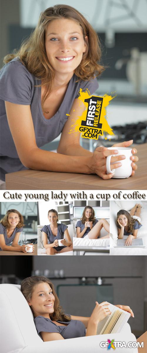 Stock Photo: Cute young lady with a cup of coffee