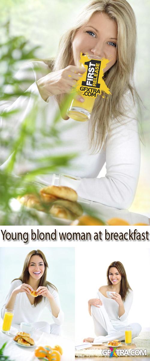 Stock Photo: Young blond woman at breakfast