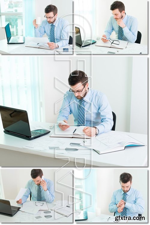 Young businessman working in office - Stock photo