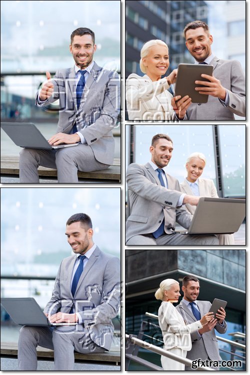 Smiling business people with laptop, tablet pc outdoors - Stock photo