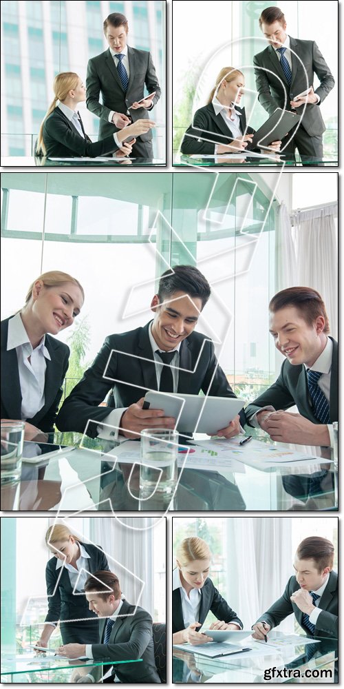 Business partners discussing documents and ideas at meeting - Stock photo