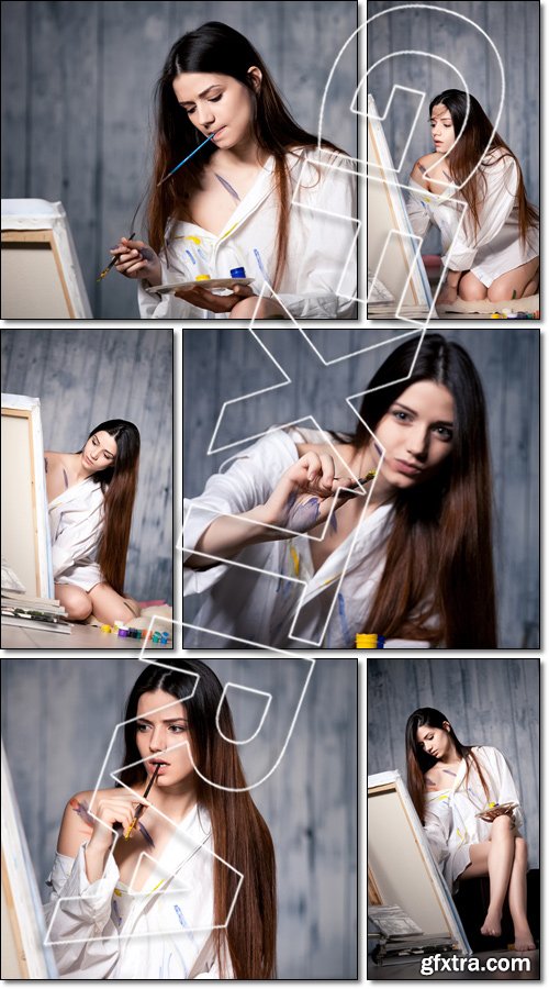 Beautiful girl draws picture in the studio smeared with paint - Stock photo
