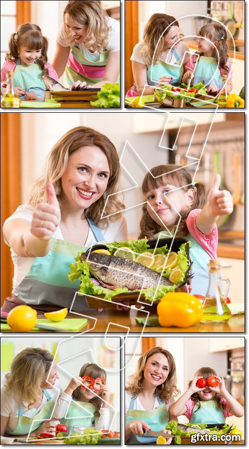 Kid girl with mom cooking fish in the kitchen - Stock photo