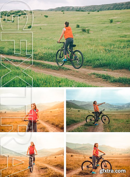Stock Photos - Beautiful girl riding on bicycle outdoor on the rural road. Wellness and sport concept