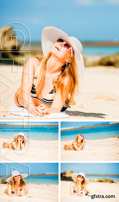 Stock Photos - Sexual brunette girl take sunbath on the beach, happy female in swimwear in sunglasses and white hat enjoying summer holidays leying on white sand