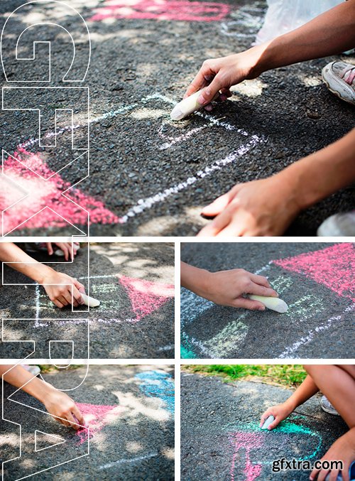 Stock Photos - Children draw in the park with chalks of various colors. Selective focus on hand