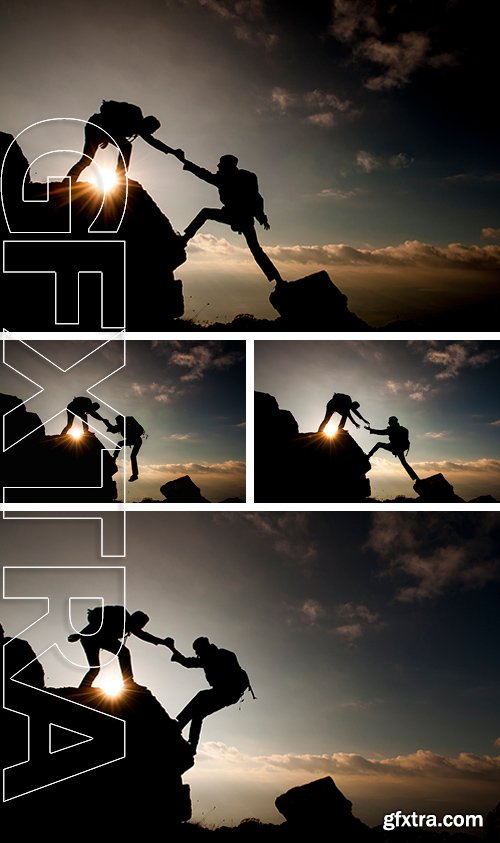 Stock Photos - Couple hiking help each other silhouette in mountains