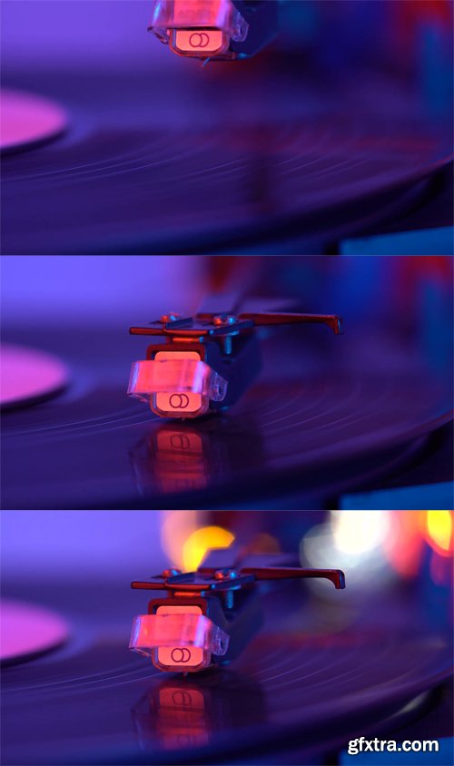 The needle drops on the disc, macro. Vinyl disc turning on retro record player