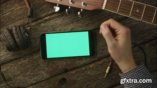Musician using phone in landscape mode at home top view causal lifestyle