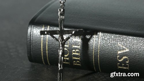 Rosary Beads Falling Onto a Bible