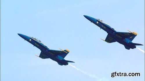 Two blue angels streaking through sky slow motion
