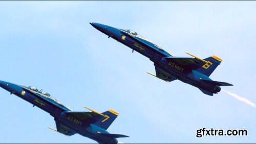 Two blue angels streaking through sky slow motion
