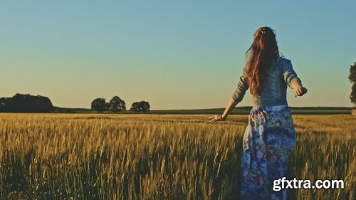 Beautiful girl running on sunlit wheat field slow motion 120 fps freedom concept happy woman having
