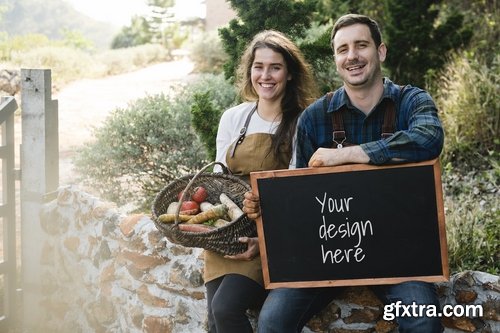 Farmer couple holding basket & blackboard mockup