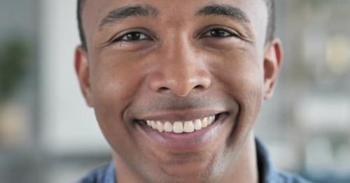 Smiling Face of Young African Man Looking at Camera