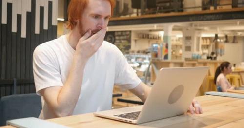 Astonished, Amazed Redhead Beard Man Working in Cafe