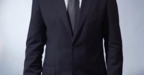 Business Written on Blackboard Man in Suit Holding Sign Leadership Goals