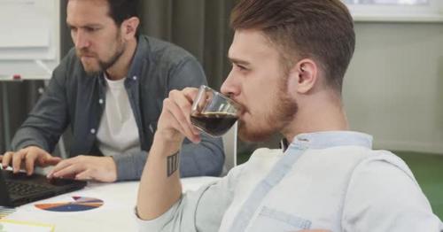 Bearded Handsome Young Businessman Drinking Coffee Thinking Looking Away