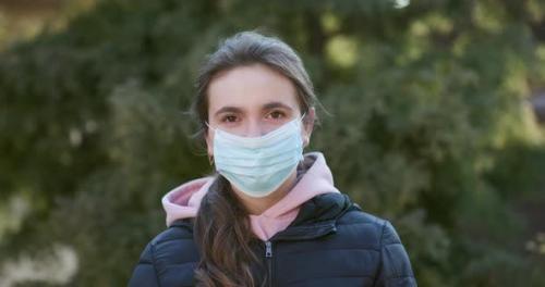 Videohive - Attractive Girl Takes on Medical Mask During Coronavirus COVID-19 Epidemic - 26181719