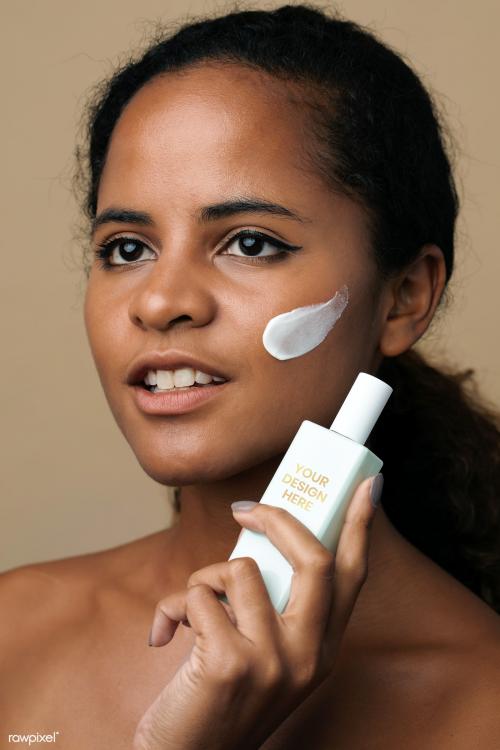 Beautiful African American woman holding a facial cream container mockup - 2209658