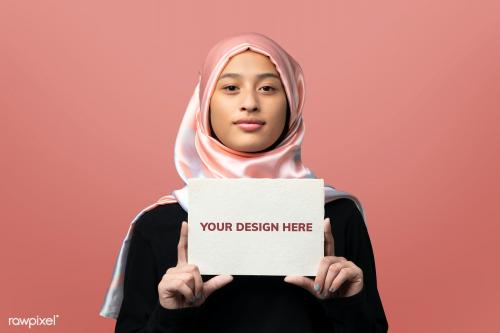 Muslim woman showing an invitation card mockup - 2210631