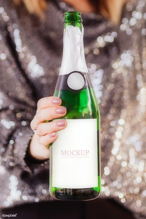 Woman holding a champagne bottle mockup - 2035824