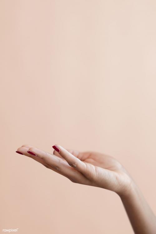 Female hand on a beige background - 1218992
