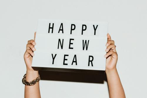 Hands holding a happy new year sign mockup - 1225200