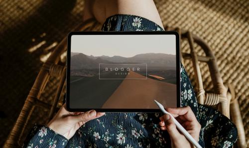 Woman blogging on a digital tablet mockup - 1226421
