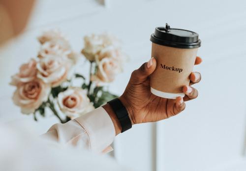 Black woman holding a paper coffee cup mockup - 1209077