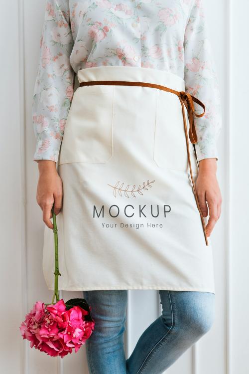 Florist in a white apron mockup holding a pink hydrangea - 1210190