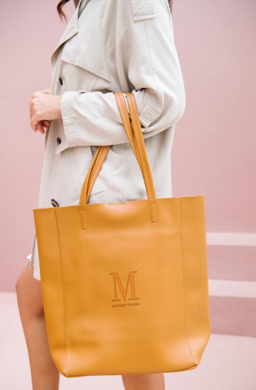 Woman carrying a brown handbag mockup - 1215152