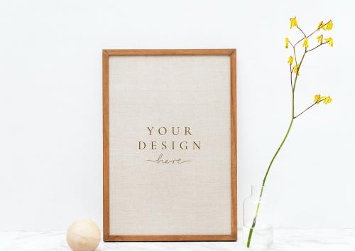Photo frame mockup by a yellow forsythia - 1215301