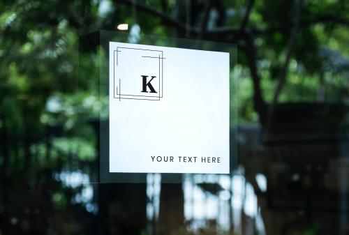 Square white shop sign mockup on a window - 844144
