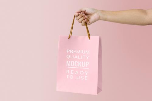 Woman holding a pink paper bag mockup - 894848