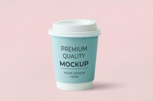 Coffee to go cup with a blue sleeve mockup on a pink background - 598458