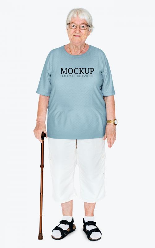 Happy elderly woman with a cane wearing a t-shirt mockup - 681326