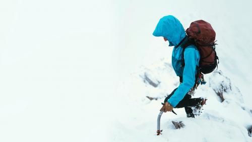 Mountaineer using an ice axe to climb Forcan Ridge in Glen Shiel, Scotland - 2221699