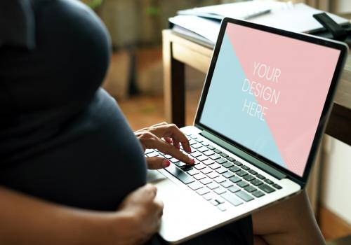 Pregnant woman is using a laptop - 844023
