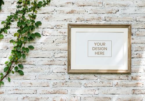 Minimal wooden picture frame on a faded brick wall - 844031